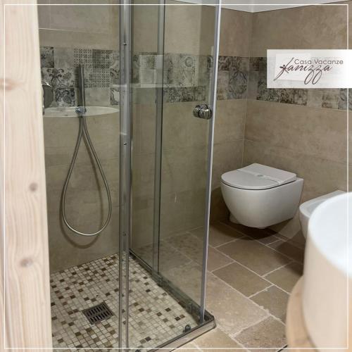 a shower stall in a bathroom with a toilet at Himeros Trulli Area in Alberobello