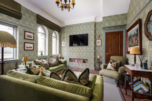 a living room with two couches and a tv at Old Town Luxury, By The Sea in Scarborough