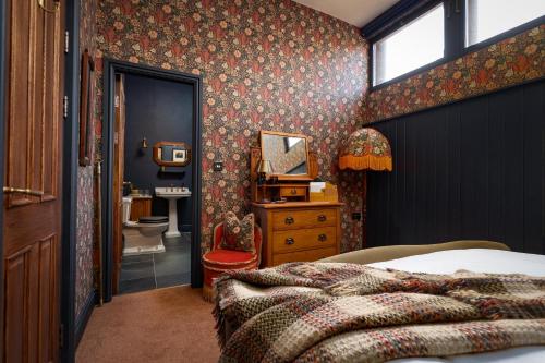 a bedroom with a bed and a bathroom at Old Town Luxury, By The Sea in Scarborough