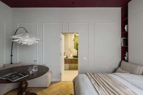 a bedroom with a table next to a bed at ROUGE Studio in Bucharest in Bucharest