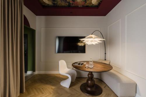 a dining room with a table and a chandelier at ROUGE Studio in Bucharest in Bucharest