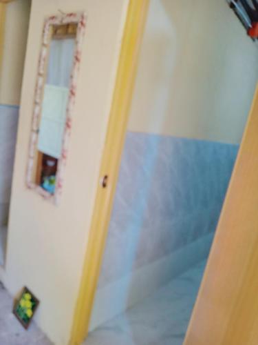 a room with a door and a mirror on a wall at JUNGLE GYM LA UNION Prana fan kubo 2 pax in Rimus