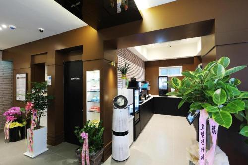a flower shop with plants and a counter at Hotel In Modern in Cheongju