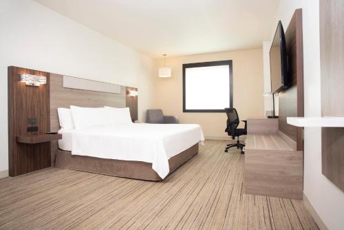 Habitación de hotel con cama y TV de pantalla plana. en Holiday Inn Express Guadalajara Iteso, an IHG Hotel en Guadalajara