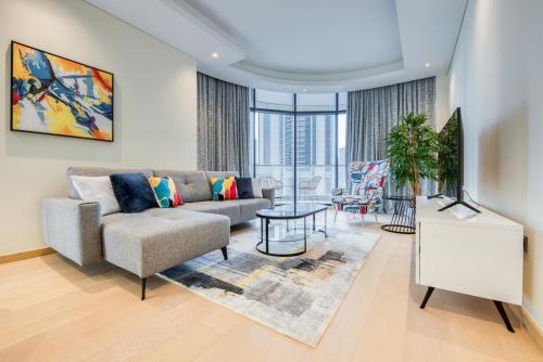 a living room with a couch and a table at RH- Downtown Delight, spacious 01BR near Dubai Mall & Burj Khalifa, RP Heights in Dubai