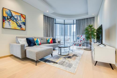 a living room with a couch and a table at RH- Downtown Delight, spacious 01BR near Dubai Mall & Burj Khalifa, RP Heights in Dubai