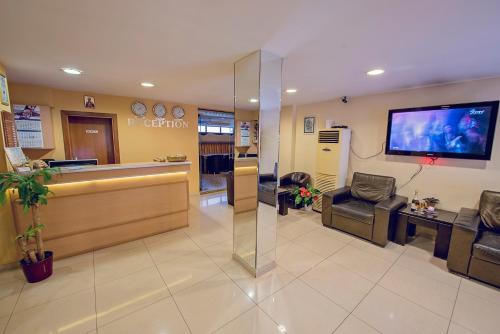 a hospital lobby with a waiting area and a tv at Supreme Victoria in Varna City