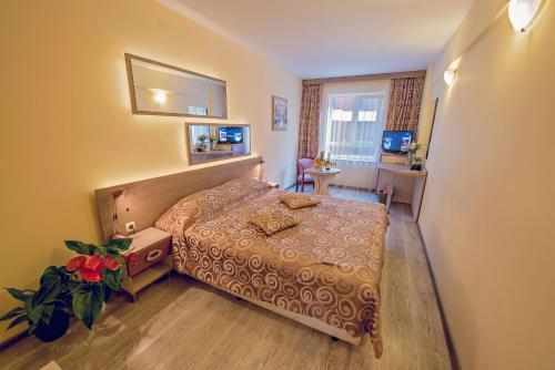 a hotel room with a bed and a window at Supreme Victoria in Varna City