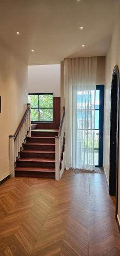 a room with a staircase and a window at Holiday Villa Novaworld Phan Thiet in Phan Thiet
