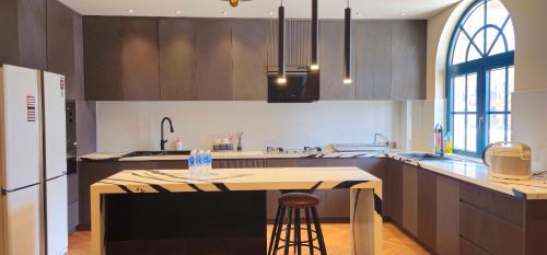 a kitchen with a island in the middle of it at Holiday Villa Novaworld Phan Thiet in Phan Thiet