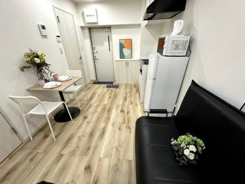a living room with a couch and a table at Nishi-Ike Apartment Room 3 in Tokyo