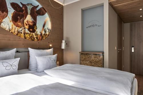 a bedroom with a large white bed and a large painting on the wall at Cocoon Hauptbahnhof in Munich