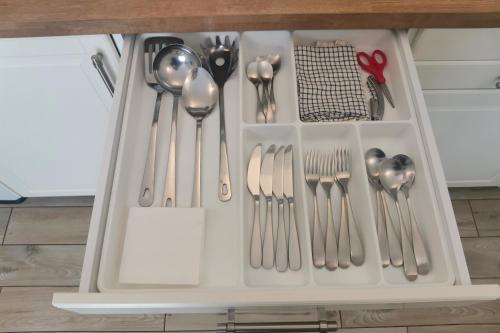 a drawer filled with silver utensils in a kitchen at Vicolo Fiore Affittacamere in Matera