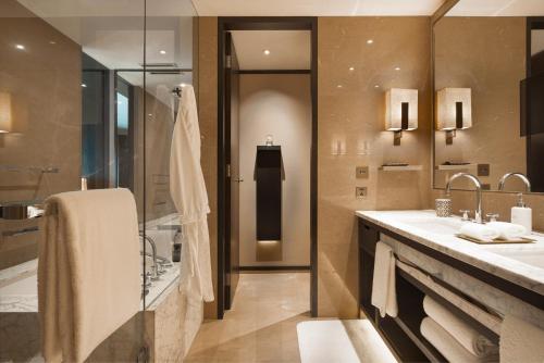 a bathroom with two sinks and a shower at Rosewood Beijing in Beijing