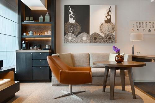 a living room with a couch and a table at Rosewood Beijing in Beijing