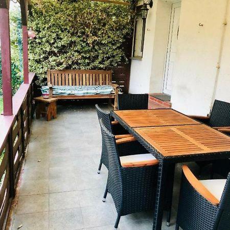 a patio with a table and chairs and a bench at Zimmer in Kyritz in Kyritz