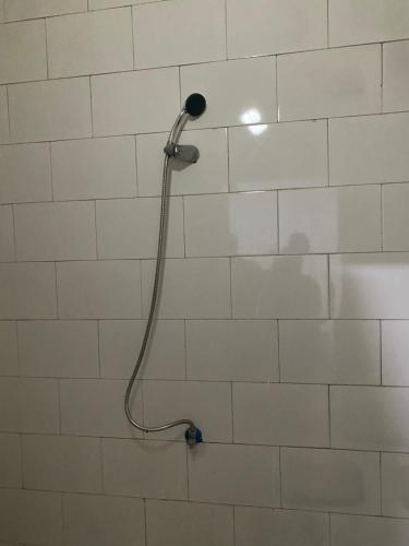 a shower with a shower head on a tiled wall at Appartement Nouakchott in Nouakchott