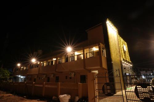 a building with lights on it at night at Hajiyar Residency in Rāmanāthapuram
