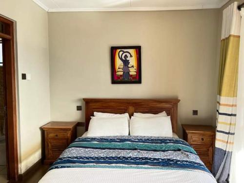 a bedroom with a bed and a picture on the wall at Harmony retreat in Nairobi