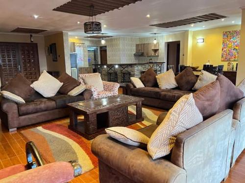 a living room with couches and a coffee table at Harmony retreat in Nairobi
