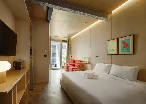 a bedroom with a large white bed in a room at Stupid Stay in Bangkok