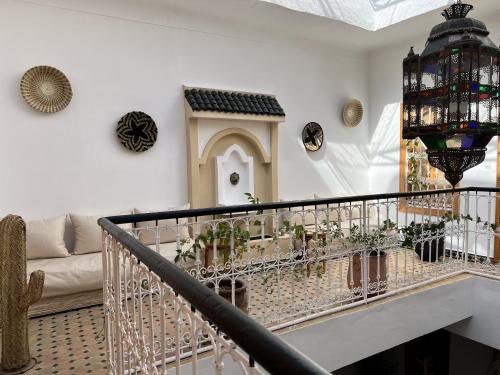 a living room with a staircase with plants on it at Riad Sarah Sabrina in Marrakesh