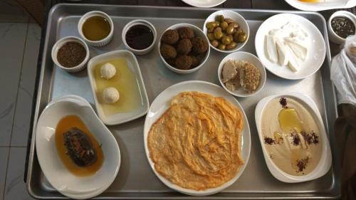 a tray of food with various foods on it at The Lodge Ajloun in Ajloun