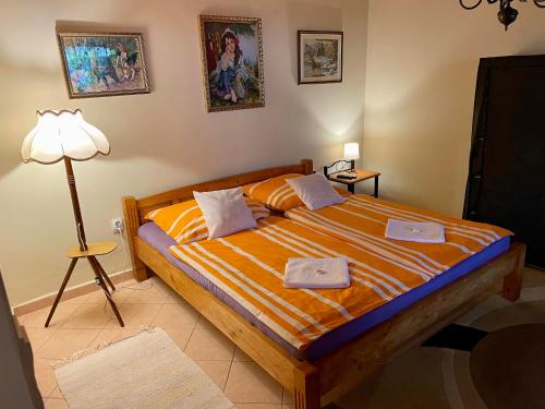 a bedroom with a bed with two towels on it at Pacsirta Vendégház in Tiszaderzs