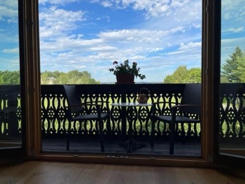 a view from a balcony with a table and a plant at Aich22 in Peißenberg