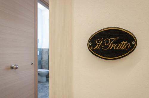 a sign that reads it authentic hanging on a bathroom door at B&B Corsini in Bologna