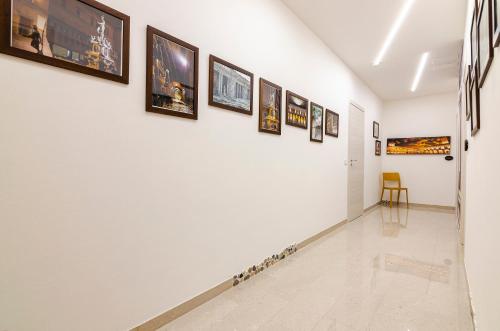 a hallway of a gallery with paintings on the wall at B&B Corsini in Bologna