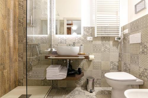 a bathroom with a sink and a toilet at B&B Corsini in Bologna
