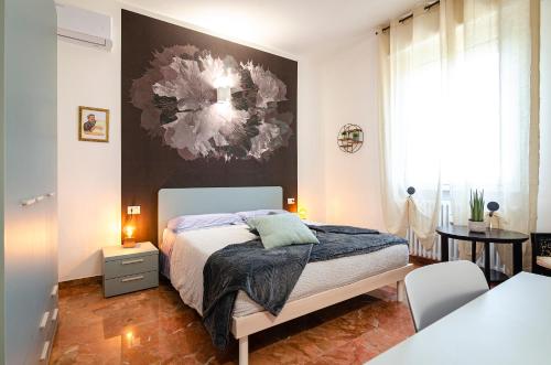 a bedroom with a bed and a painting on the wall at B&B Corsini in Bologna