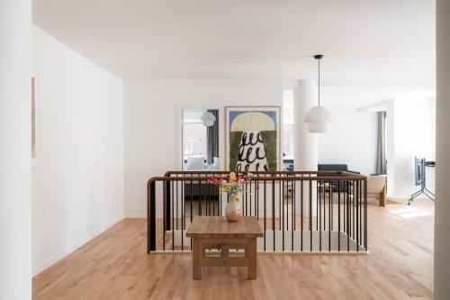 a living room with a vase on a table at Queens Courtyard by Daniel&Jacob's in Copenhagen