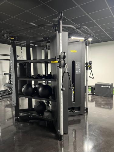 a gym with two rows of boxing equipment at Stylish 2 bedrooms, 2 bathrooms with workspace in Milton Keynes in Milton Keynes