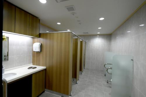 a bathroom with a toilet and a sink and a mirror at Toyoko Inn Changwon in Changwon