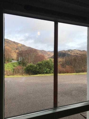 a view from a window of an empty road at Lochailort Inn in Lochailort