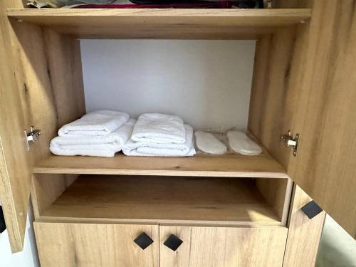 a wooden cabinet with towels sitting in it at Mtour Apartment in Gyumri