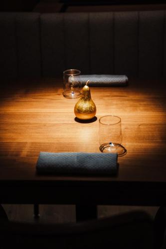 a wooden table with two candles and a pot on it at Parkhotel Graz - Traditional Luxury in Graz