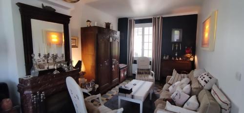 un salon avec un canapé et une table dans l'établissement Une chambre en ville, à Domfront