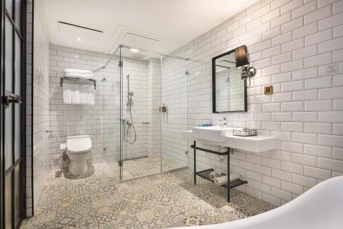 a bathroom with a shower and a sink and a toilet at BlueSky Hotel in Taichung