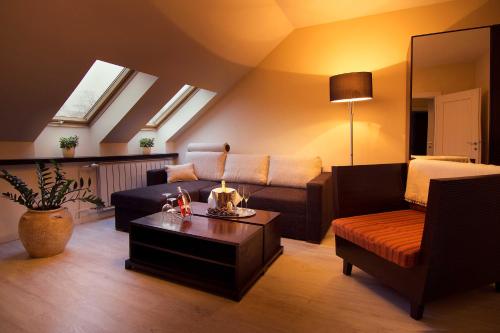 a living room with a couch and a coffee table at City Residence Apartment Hotel in Košice