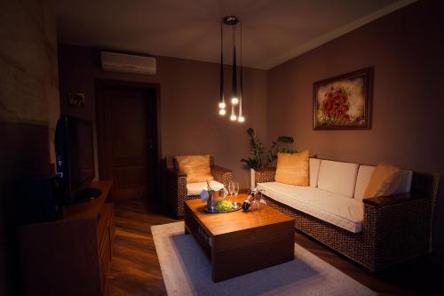 a living room with a couch and a coffee table at City Residence Apartment Hotel in Košice