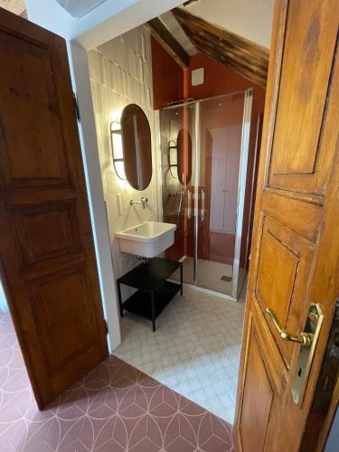 a bathroom with a sink and a mirror at Altana della Ruggera in Modena