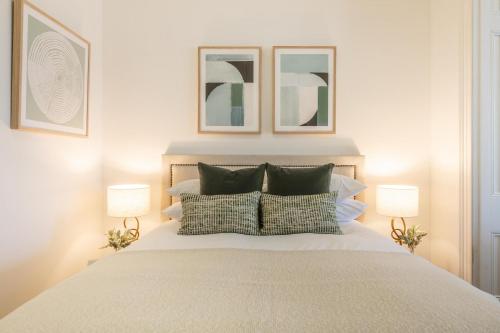 a bedroom with a large white bed with two lamps at Modern 1-Bed Studio near Tramsheds in Sydney