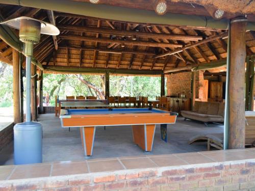 a ping pong table sitting inside of a building at Masungulo Lodge in Modimolle