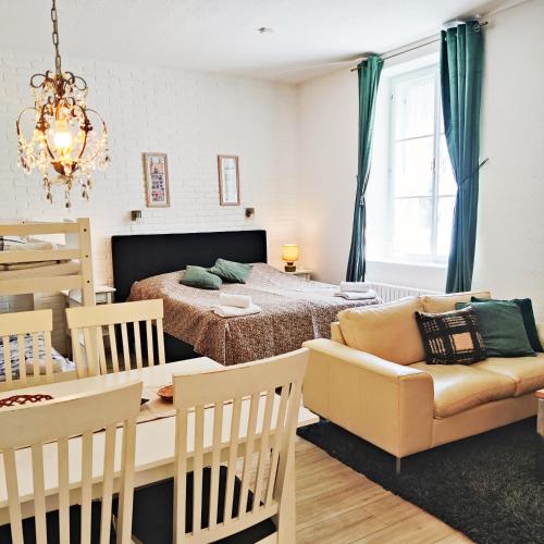 a bedroom with a bed and a table and a couch at Penzion Stranny in Stranný