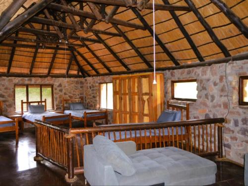 una habitación con sofás y sillas en un edificio en Masungulo Lodge, en Modimolle