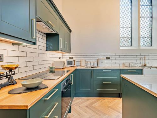 a kitchen with blue cabinets and a bowl on a counter at 4 Bed in Soudley 94433 in Lower Soudley