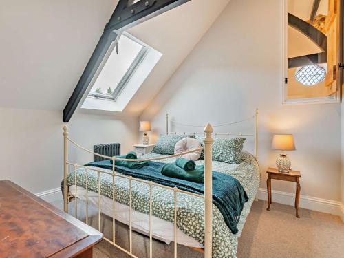 a bedroom with a metal bed in a attic at 4 Bed in Soudley 94433 in Lower Soudley